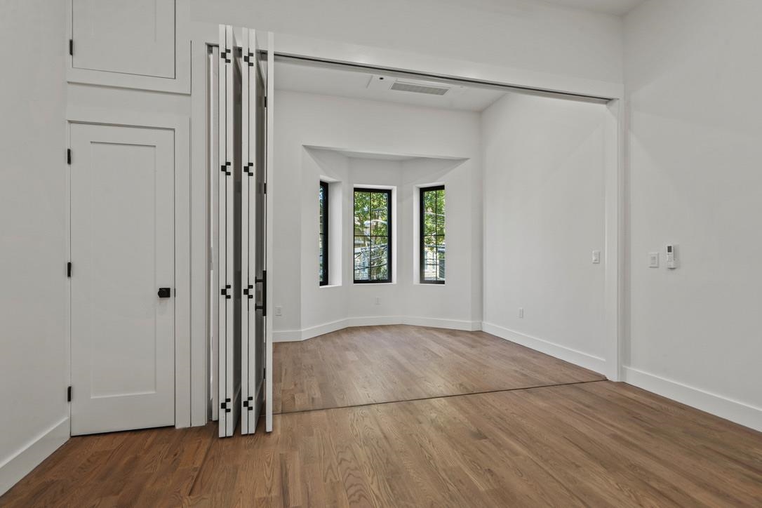 41 47th Street, Unit 2 Weehawken, NJ 07086 - Photo 19 of 22 a view of an empty room with wooden floor and a window