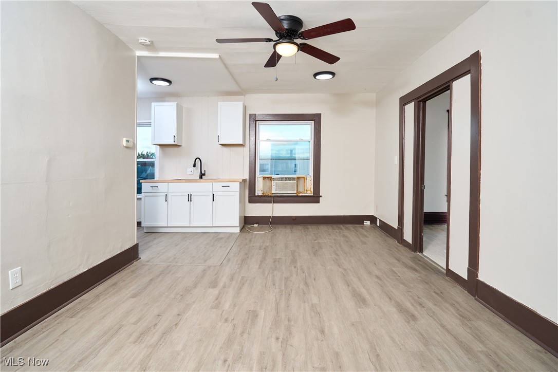 5432 State Road Parma, OH 44134 - Photo 26 of 47 Unfurnished living room with light wood-style flooring, healthy amount of natural light, and ceiling fan