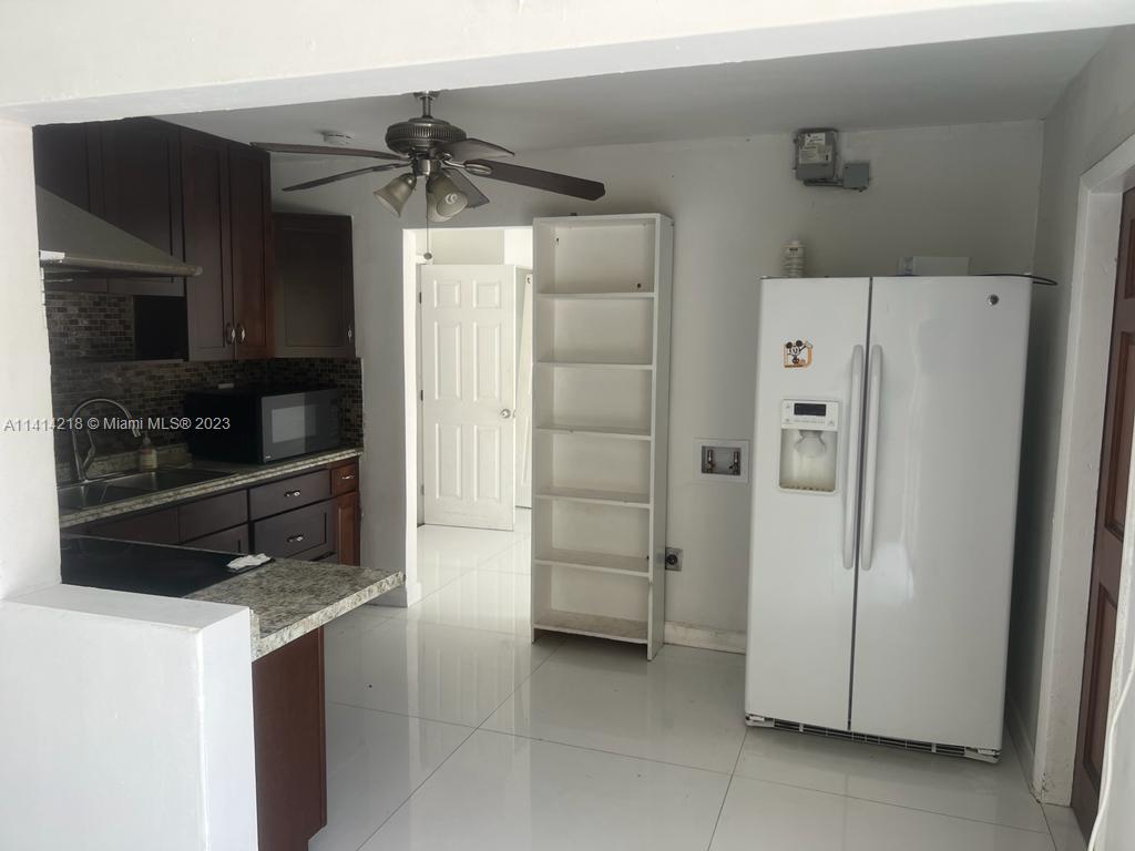 3637 Southwest 14th Street, Unit 2 Miami, FL 33145 - Photo 3 of 9 a kitchen with a refrigerator and a stove