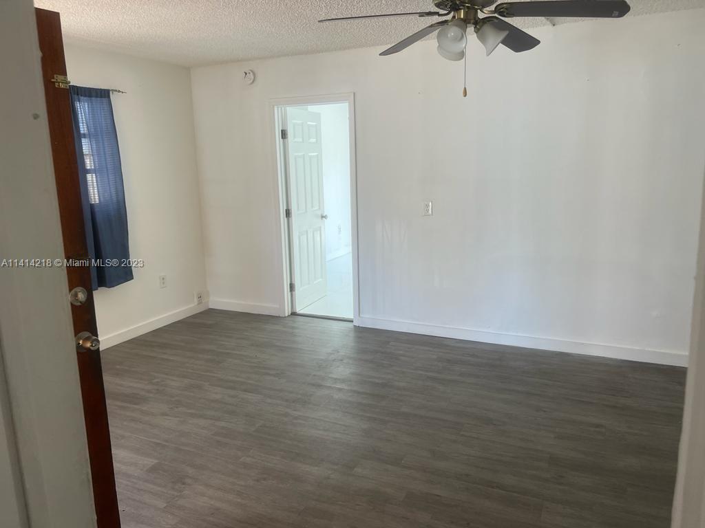 3637 Southwest 14th Street, Unit 2 Miami, FL 33145 - Photo 5 of 9 a view of an empty room with wooden floor