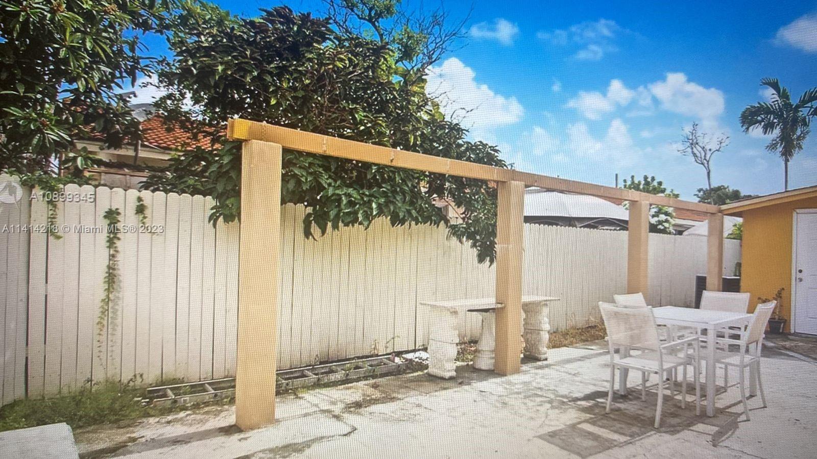 3637 Southwest 14th Street, Unit 2 Miami, FL 33145 - Photo 9 of 9 a view of a patio with a table and chairs