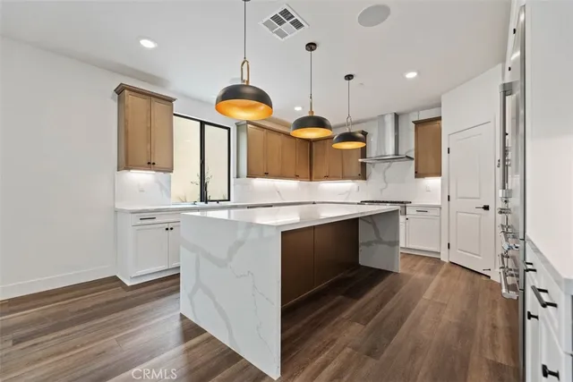 a kitchen with stainless steel appliances granite countertop a sink a stove and a refrigerator