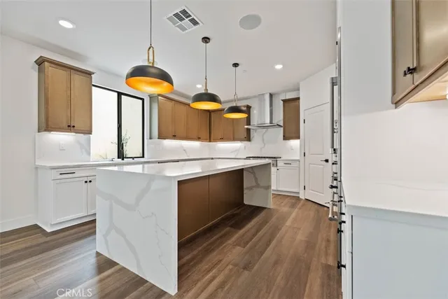 a kitchen with stainless steel appliances granite countertop a sink a stove and a refrigerator