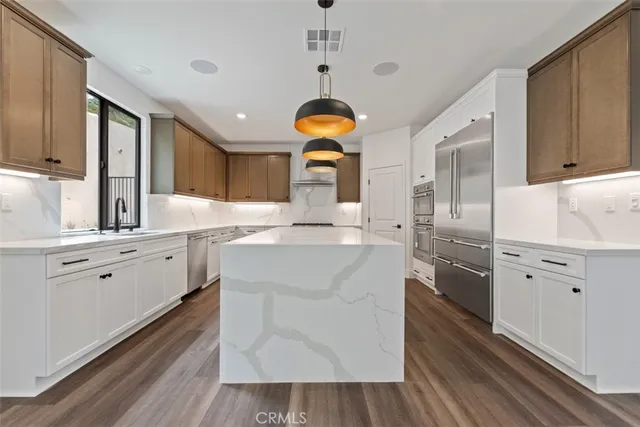 a kitchen with cabinets a sink and appliances