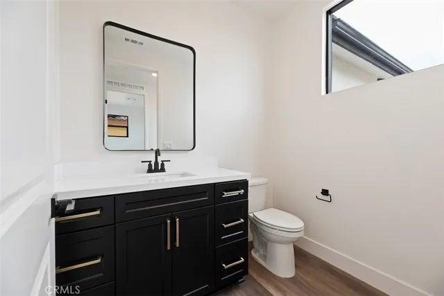 a bathroom with a toilet a sink and mirror