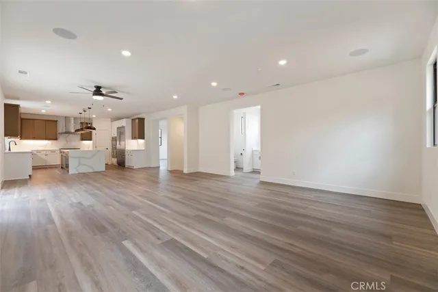 a view of a living room kitchen with furniture and wooden floor