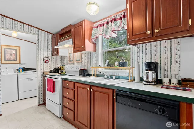 a kitchen with a sink cabinets and window