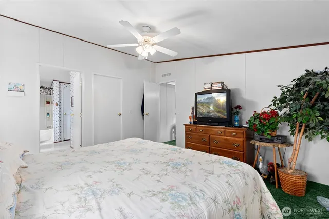 a bedroom with a large bed and a chandelier