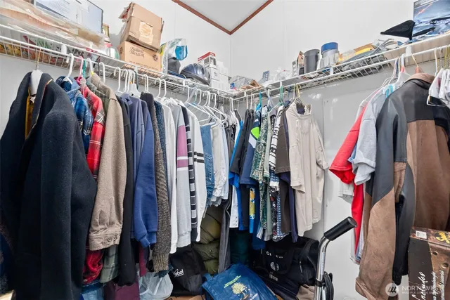 a view of walk in closet with clothes and shoes