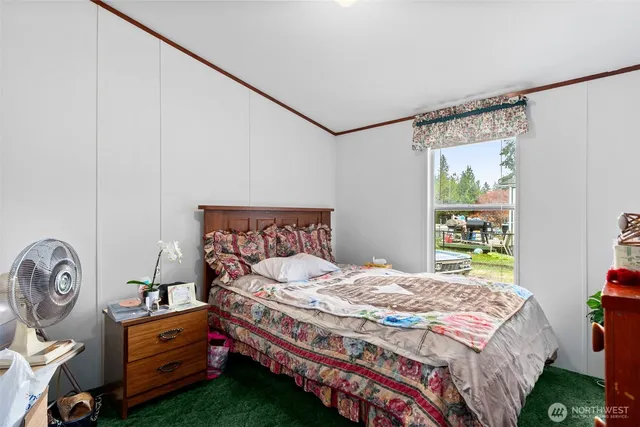 a bedroom with a bed and a window in it