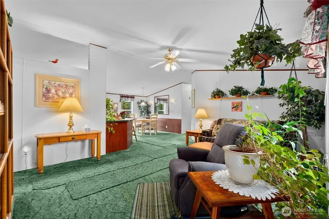 a living room with furniture and a potted plant