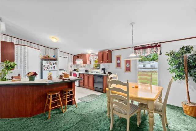 a view of a dining room with furniture and a window