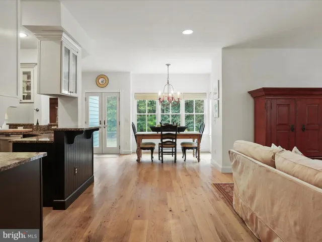 a kitchen with granite countertop a sink a stove and cabinets