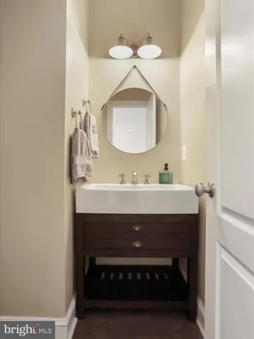 a bathroom with a granite countertop sink a large mirror and vanity