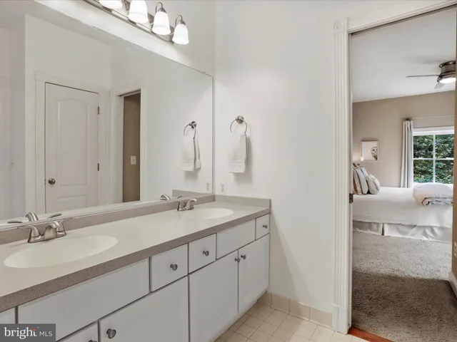 a bathroom with a sink a large mirror and a bathtub