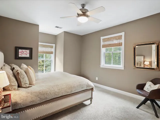 a spacious bathroom with a granite countertop sink mirror and bathtub