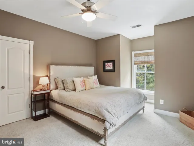 a spacious bathroom with a tub a sink and a mirror