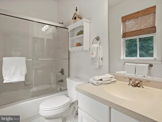 a spacious bedroom with a bed and a large window