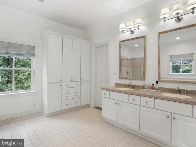 a view of walk in closet with clothes