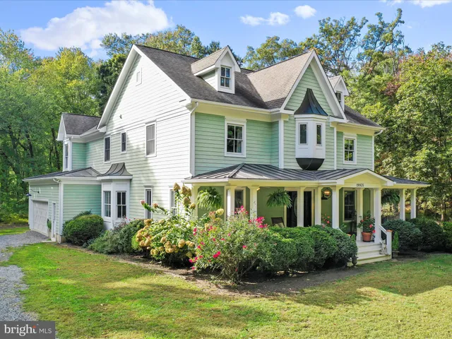 a dining room with furniture a chandelier and wooden floor