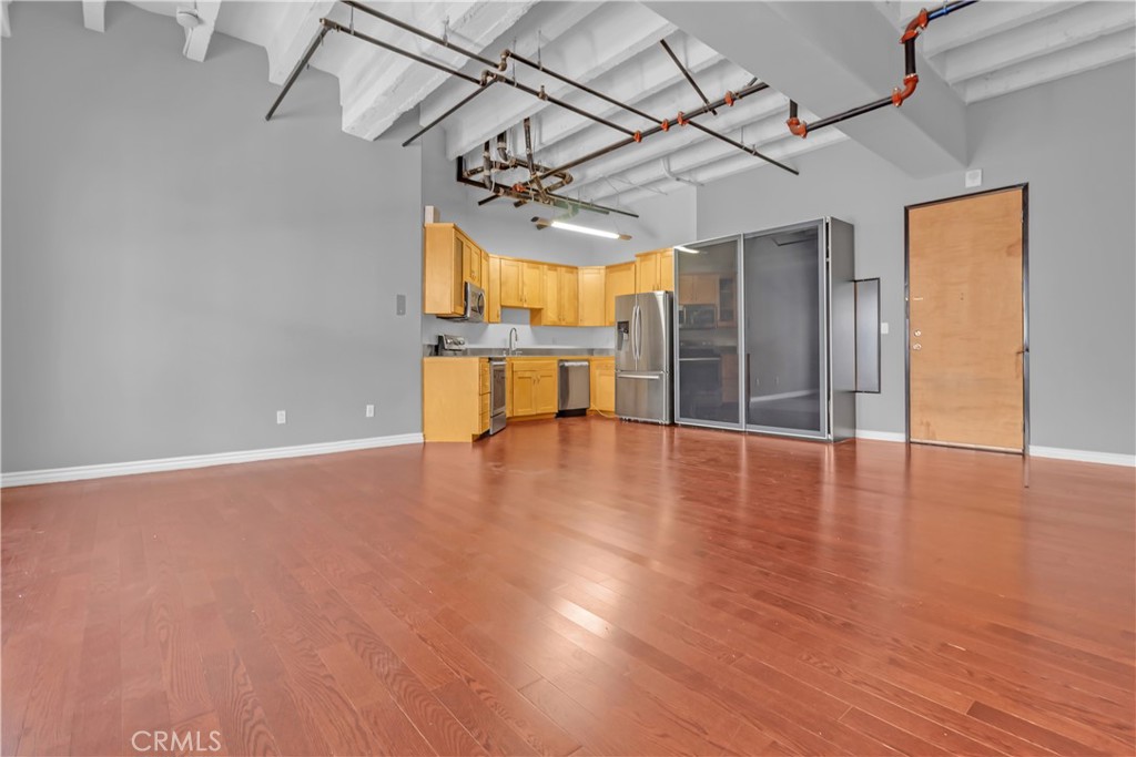 312 West 5th Street, Unit 1109 Los Angeles, CA 90013 - Photo 10 of 47 an empty room with wooden floor and windows