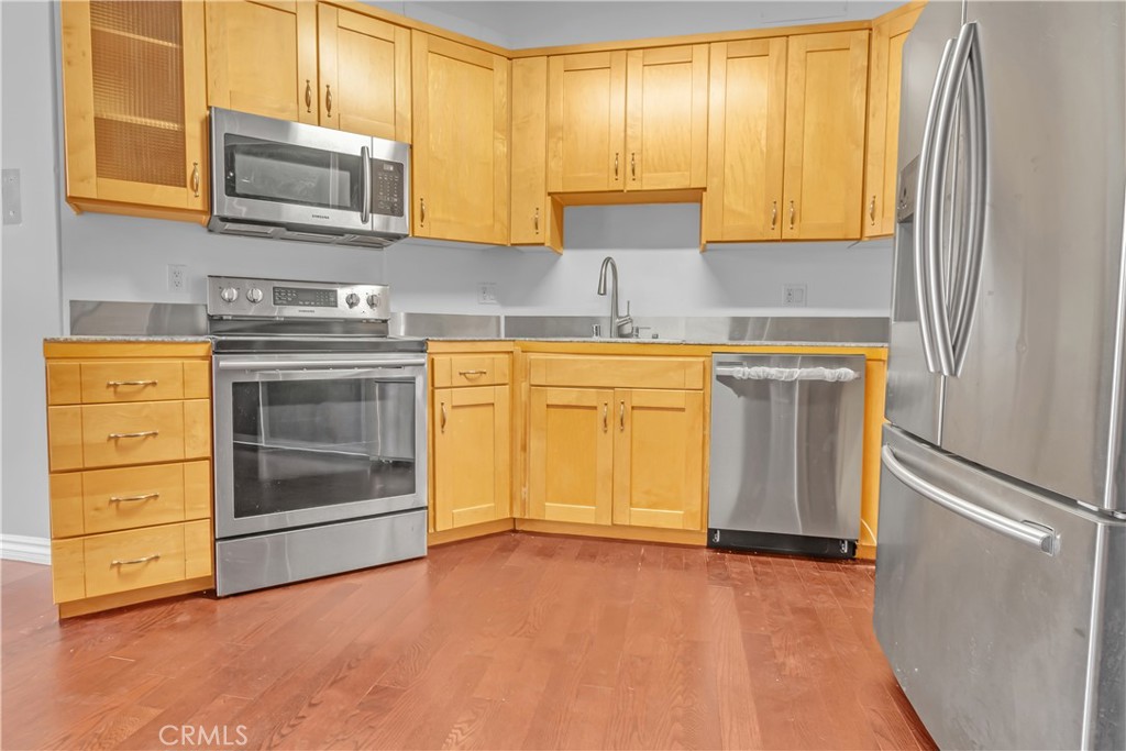 312 West 5th Street, Unit 1109 Los Angeles, CA 90013 - Photo 11 of 47 a kitchen with granite countertop cabinets stainless steel appliances and a sink