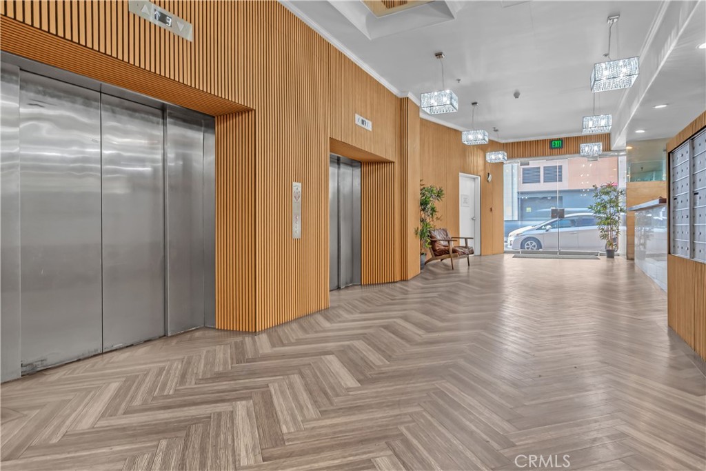 312 West 5th Street, Unit 1109 Los Angeles, CA 90013 - Photo 16 of 47 a view of a hallway with a table and chairs