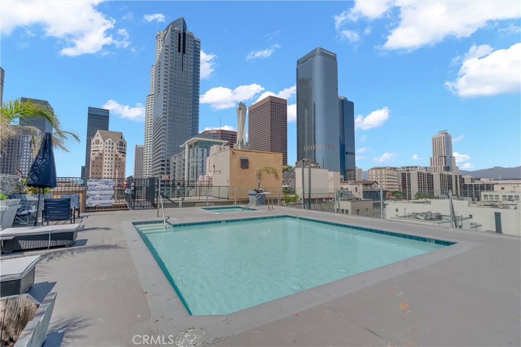 312 West 5th Street, Unit 1109 Los Angeles, CA 90013 - Photo 30 of 47 a swimming pool with outdoor seating and city view