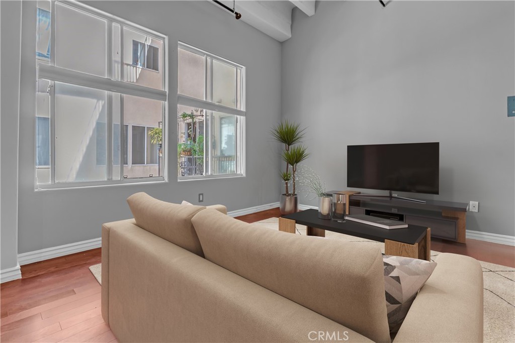 312 West 5th Street, Unit 1109 Los Angeles, CA 90013 - Photo 5 of 47 a living room with furniture and a flat screen tv