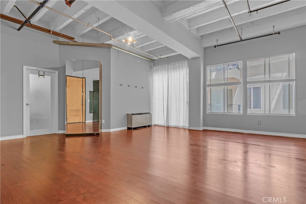 312 West 5th Street, Unit 1109 Los Angeles, CA 90013 - Photo 47 of 47 a view of an empty room with wooden floor and a window