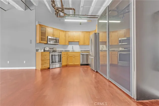 a kitchen with granite countertop cabinets stainless steel appliances and a sink