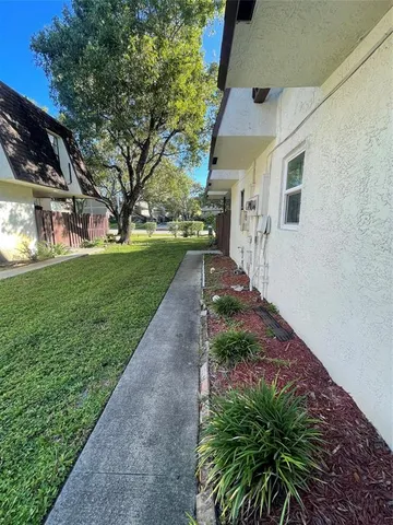 a pathway of a house with a yard