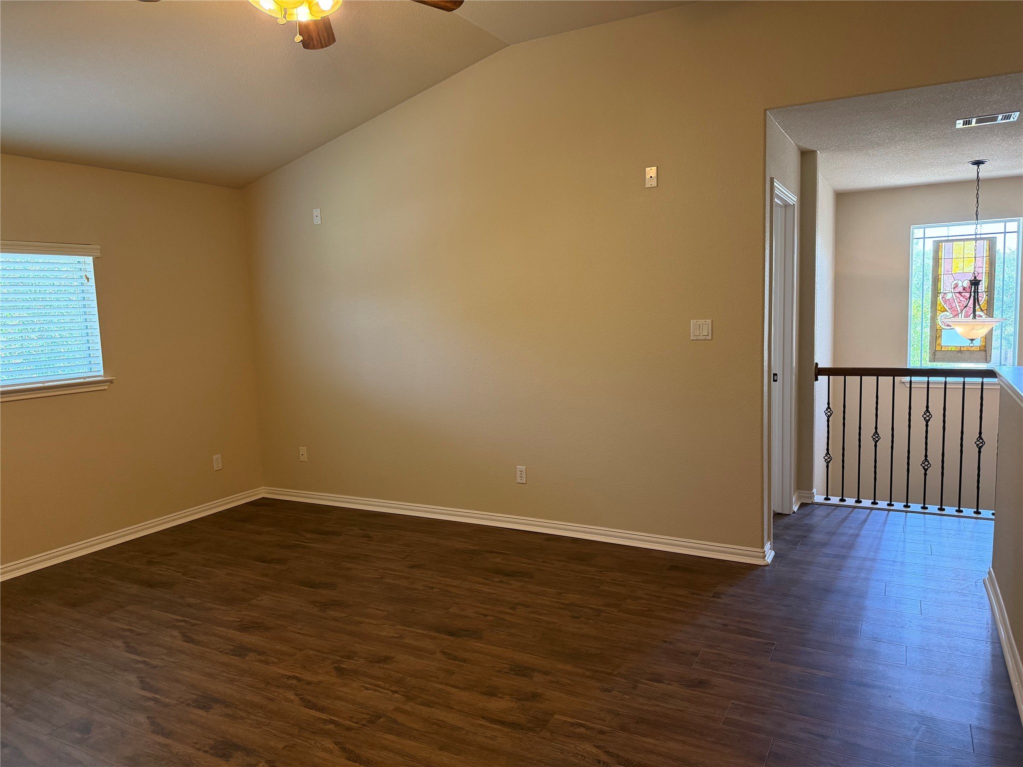 3021 Grand Mission Way Pflugerville, TX 78660 - Photo 23 of 31 A versatile open-concept space featuring rich wood-look flooring and a charming stained-glass window.