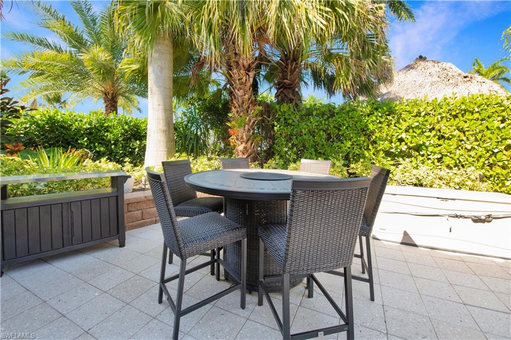 13553 Snapper Lane Naples, FL 34114 - Photo 13 of 24 a view of a patio with table and chairs and potted plants