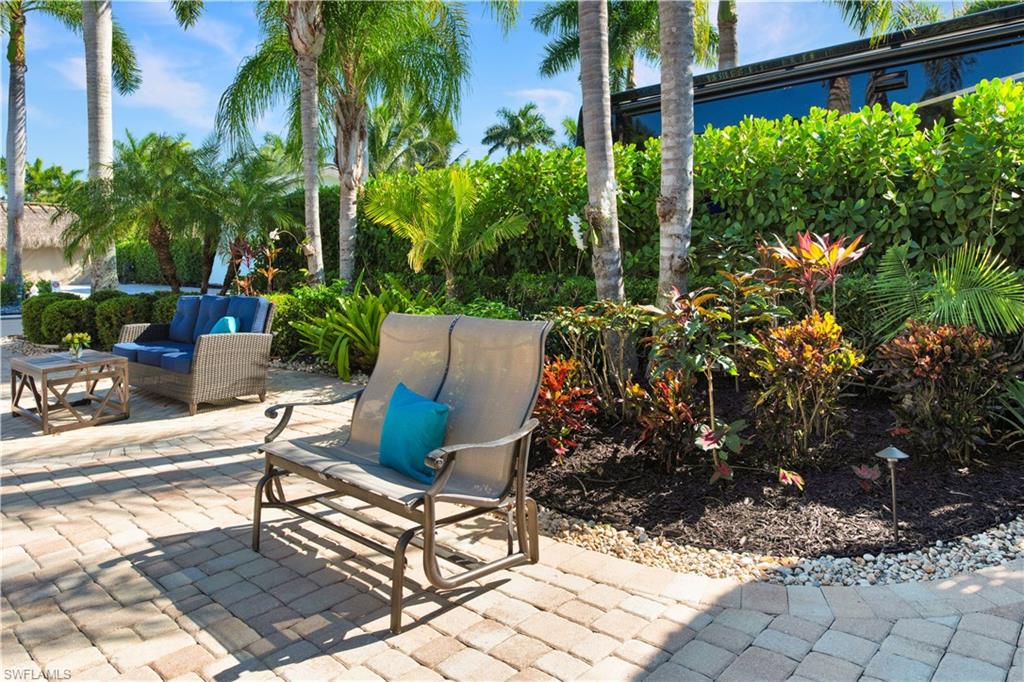 13553 Snapper Lane Naples, FL 34114 - Photo 8 of 24 a view of a chairs and table in a backyard