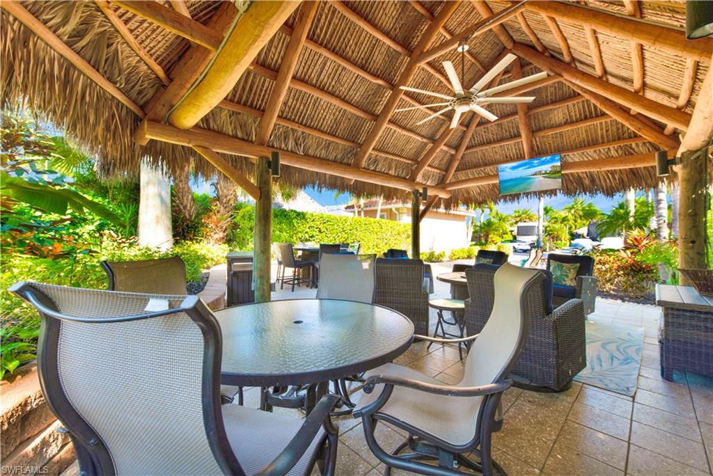 13553 Snapper Lane Naples, FL 34114 - Photo 9 of 24 a view of a patio with a table and chairs