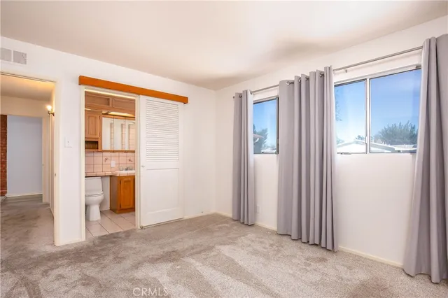 a view of a room with a bathroom and a window