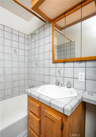 a view of a room with wooden floor and white walls