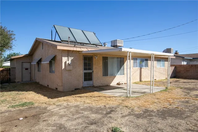 a view of a house with wooden fence