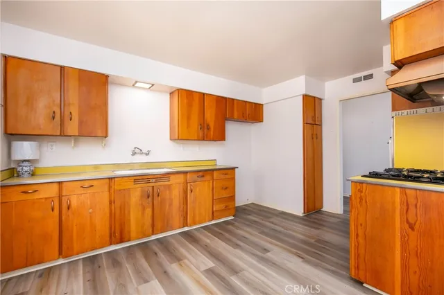 a view of a kitchen with wooden floor and a sink