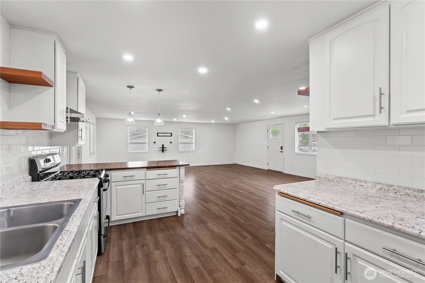 2229 Southwest 330th Street Federal Way, WA 98023 - Photo 17 of 30 a kitchen with granite countertop a sink a stove and cabinets