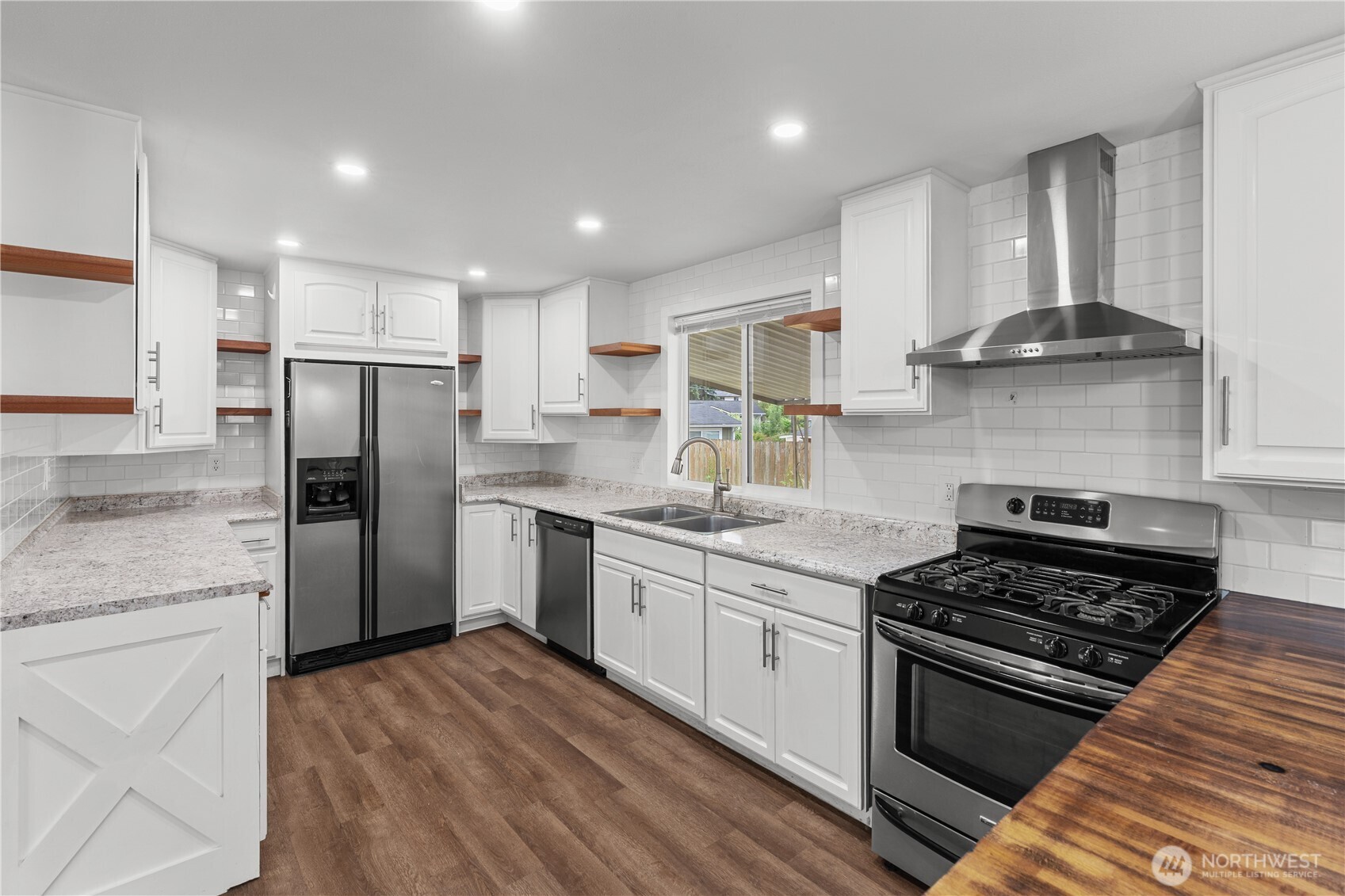 2229 Southwest 330th Street Federal Way, WA 98023 - Photo 18 of 30 a kitchen with stainless steel appliances granite countertop a stove a refrigerator and a sink