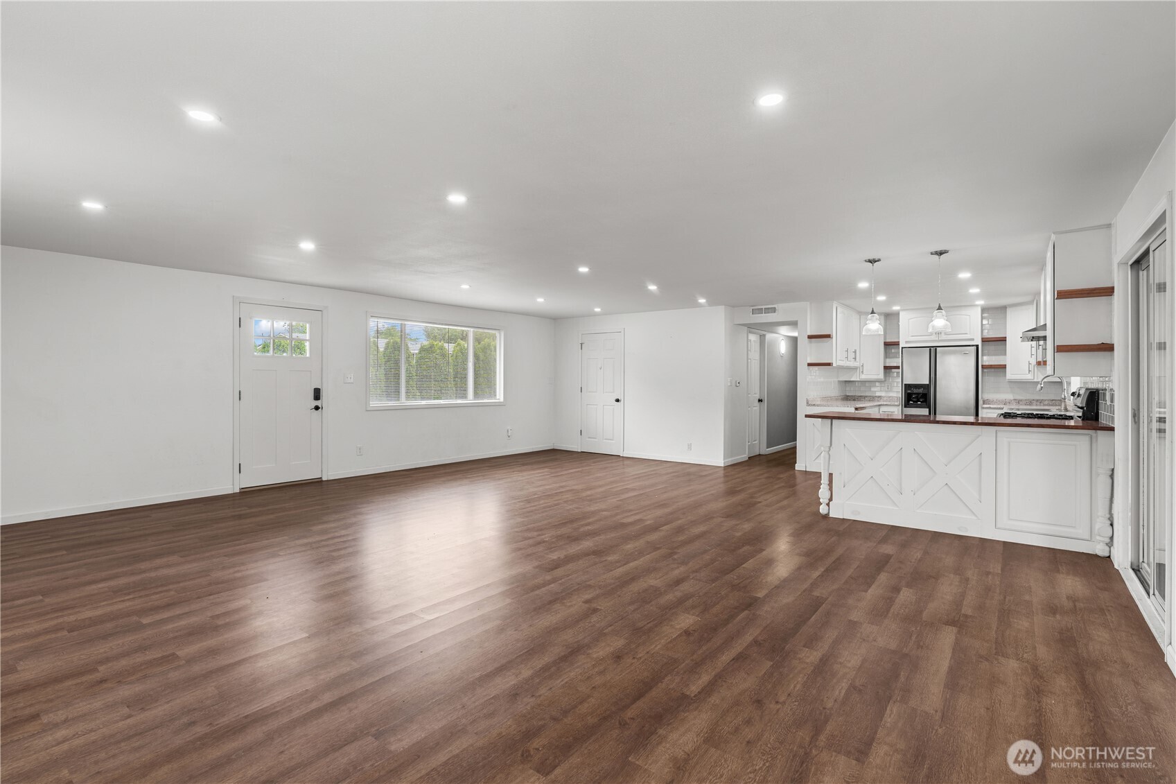 2229 Southwest 330th Street Federal Way, WA 98023 - Photo 24 of 30 a view of an empty room and a kitchen with wooden floor