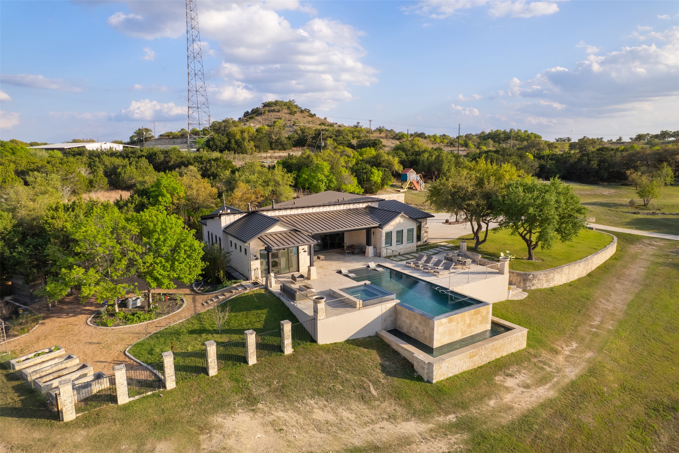Primary residence with large open patio and infinity pool overlooking the private 3acre lake.