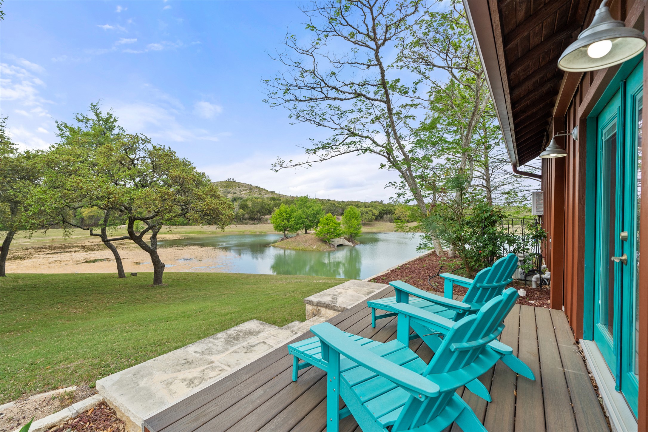 101 Rolling Hills Road Blanco, TX 78606 - Photo 34 of 40 a view of a lake with a table and chairs