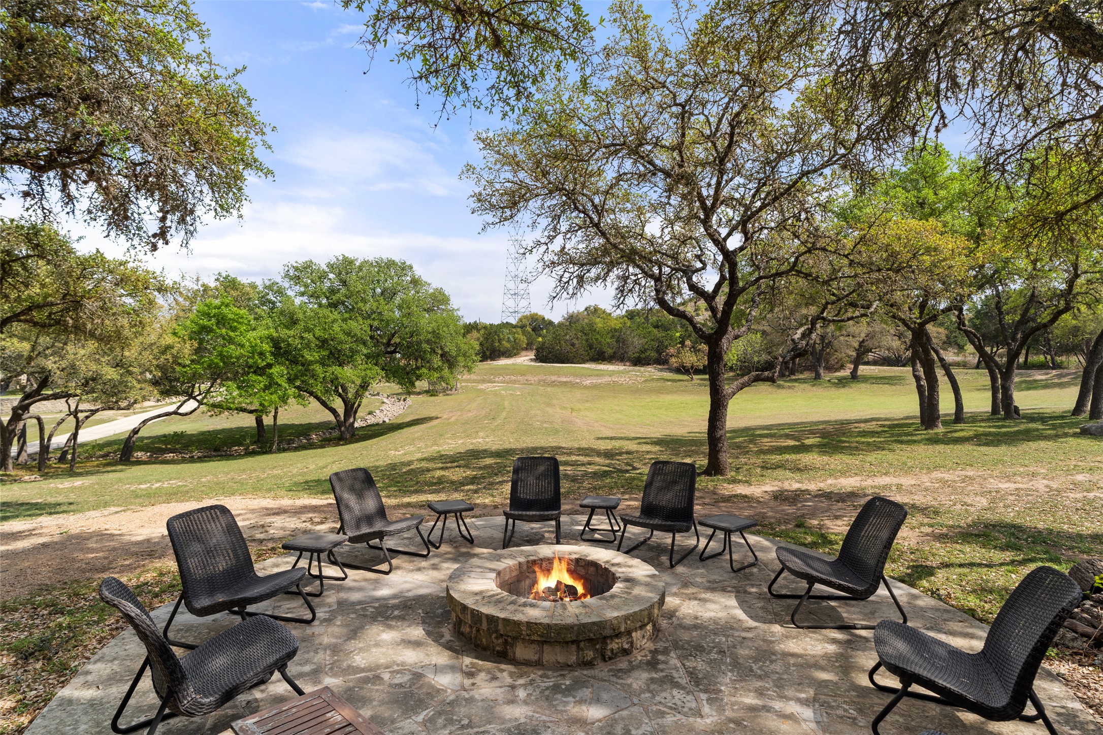 101 Rolling Hills Road Blanco, TX 78606 - Photo 35 of 40 a view of a patio with lawn chairs under an umbrella