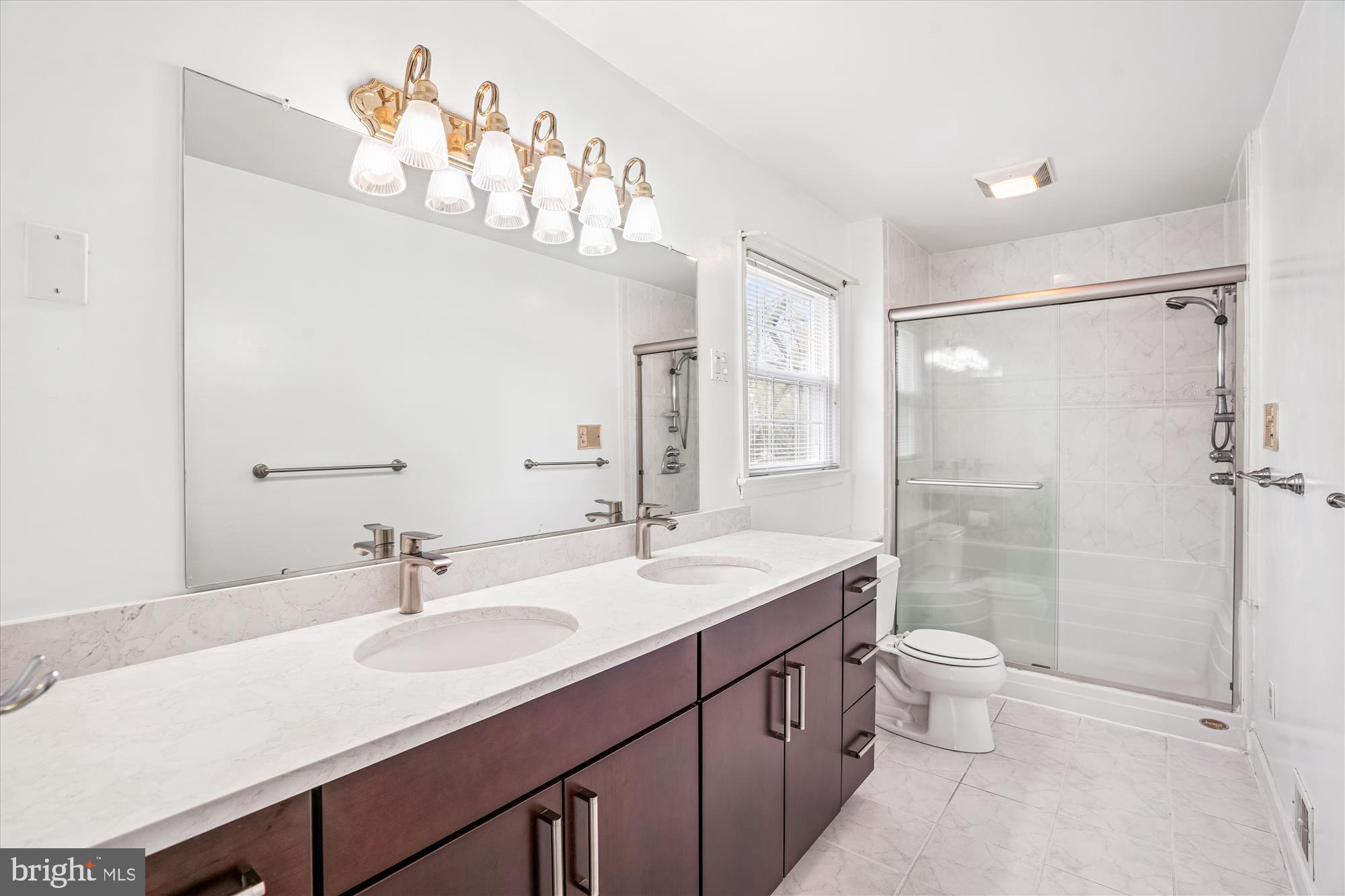 1913 Hopefield Road Silver Spring, MD 20905 - Photo 33 of 58 a bathroom with a double vanity sink mirror and shower