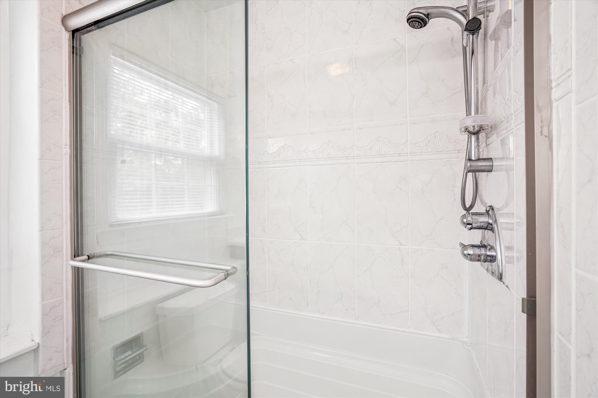 1913 Hopefield Road Silver Spring, MD 20905 - Photo 34 of 58 a bathroom with a glass shower door