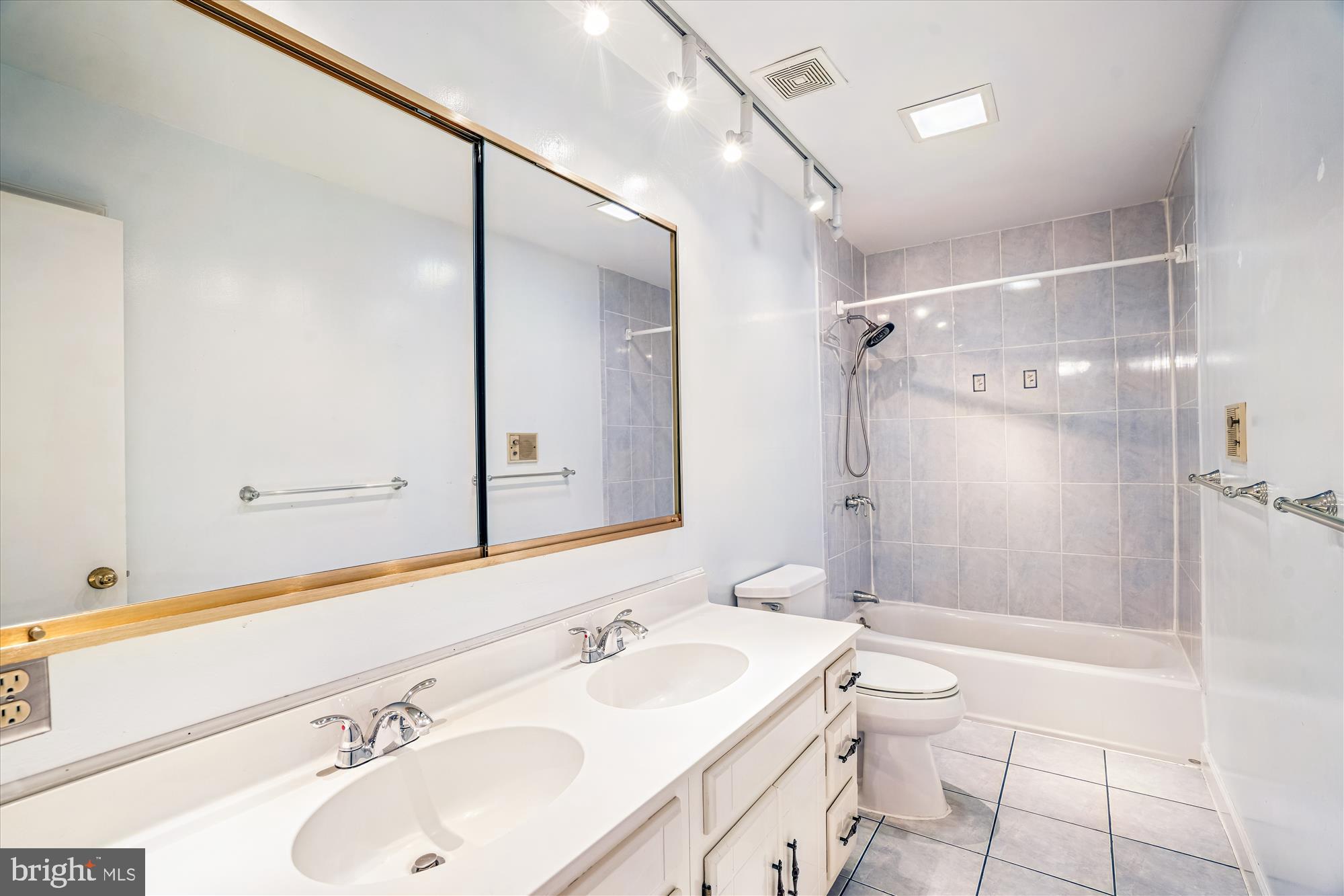 1913 Hopefield Road Silver Spring, MD 20905 - Photo 37 of 58 a bathroom with a sink mirror vanity shower and a toilet