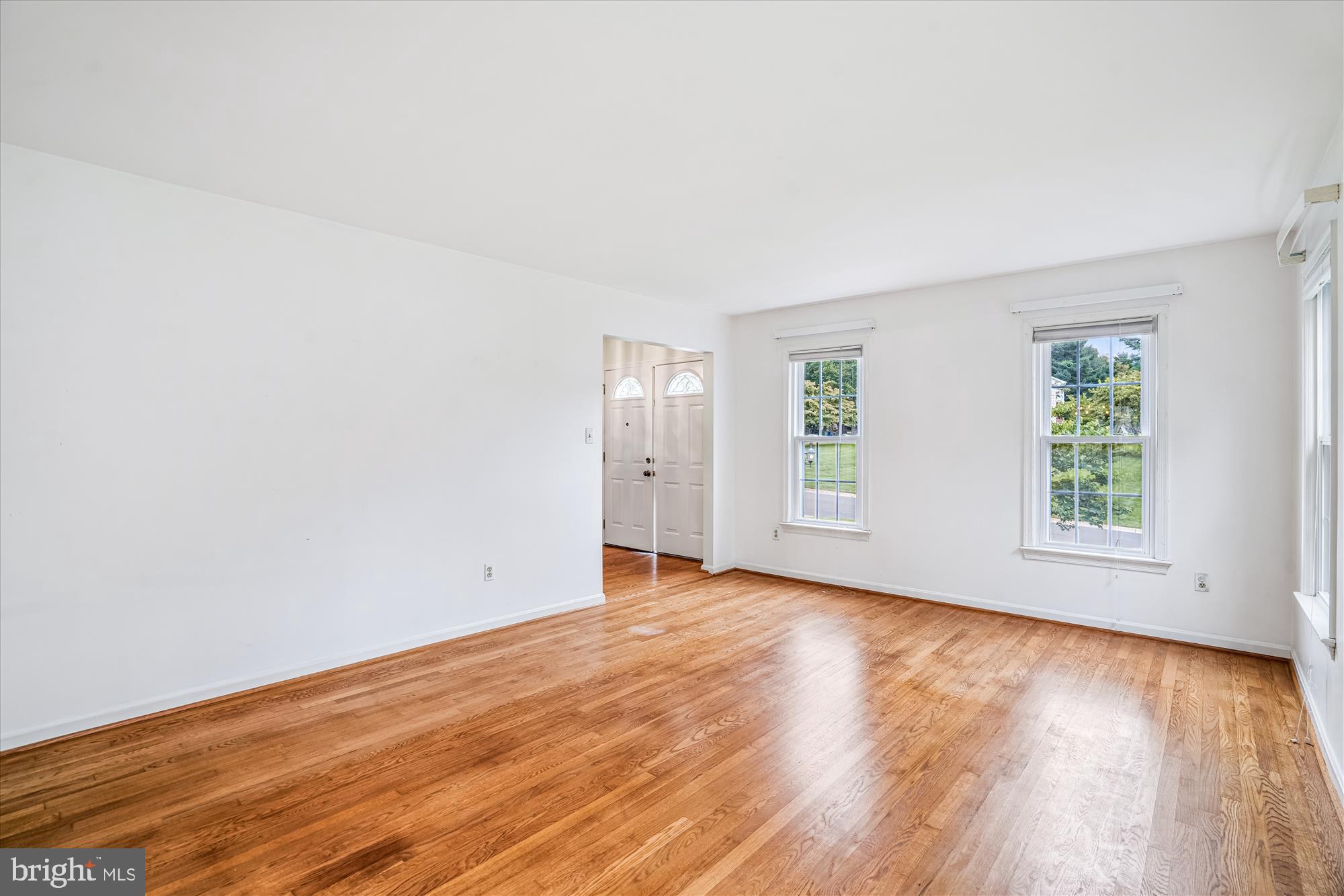 1913 Hopefield Road Silver Spring, MD 20905 - Photo 7 of 58 an empty room with wooden floor and windows